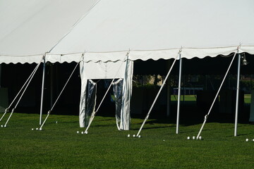 Entrance to white tent with support rigging