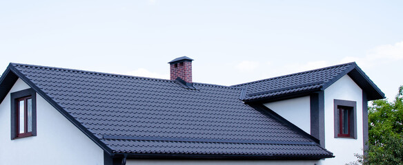 The roof of the dark color of the new house - obrazy, fototapety, plakaty