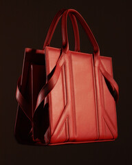 big red women's bag on a black background