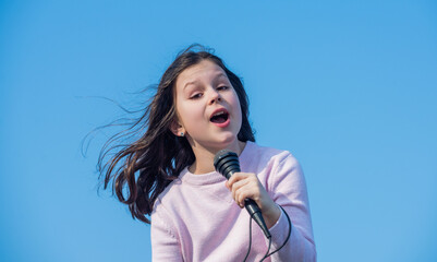 happy teen girl singing karaoke in mic