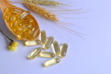 Fish oil capsules or cod liver oil capsules on the spoon white background.