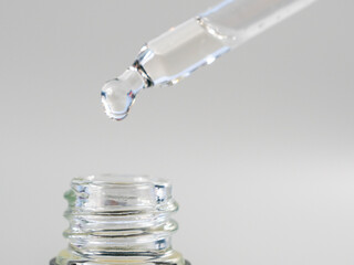 Oil for skin care is dripping with a pipette.