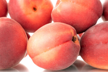 Several ripe red apricots, close-up, isolated on a white background.