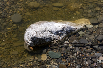 large white stones lie near the sea