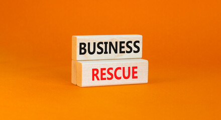 Business rescue symbol. Concept words Business rescue on wooden blocks on a beautiful orange table orange background. Business rescue and support concept. Copy space.