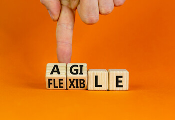 Flexible and agile symbol. Concept words Flexible and agile on wooden cubes. Businessman hand....