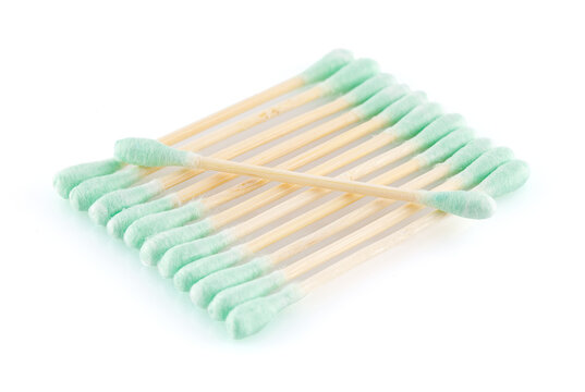 Eco-friendly materials. Wooden, cotton swabs on a white background. Close-up.