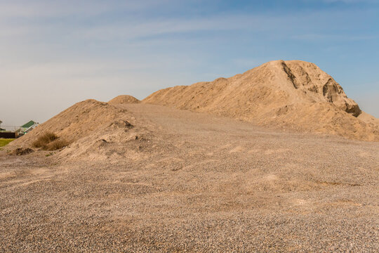 A stockpile of inert building materials. A large pile of sand and gravel. High resolution photo.
