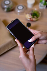 a black smartphone in female hands. phone template