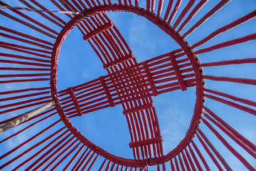 The wooden details of the Asian yurt lie on the pavement. Assembling the yurt.