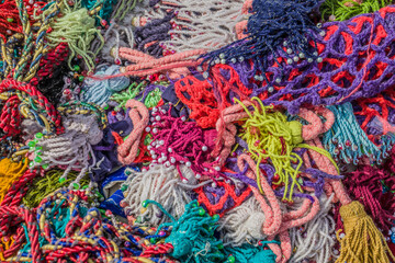 Multi-colored threads and fringe made of wool. Ornament for a yurt.