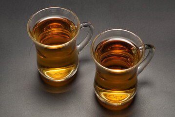 A turkish glass of tea on black background.