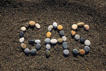 word gas on sandy beach. Energy and fuel concept