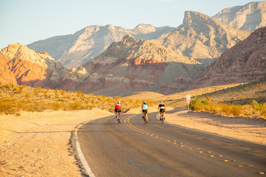 bikers on a desert road with colorful red rocks - Powered by Adobe