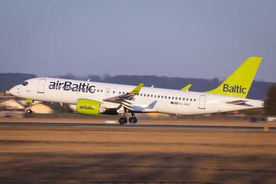 Air Baltic Airbus A220 landing in Graz, Austria coming from Stuttgart in beautiful sun light