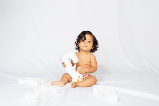 Hispanic baby photo studio with white background
