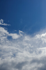 Natural background of fluffy white clouds on blue sky 