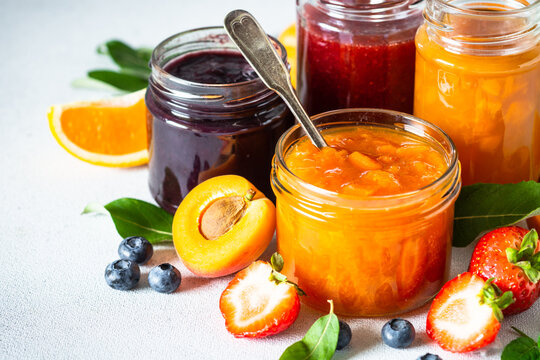Homemade jams, natural preservation in glass jars with ingredients, fresh fruits and berries.