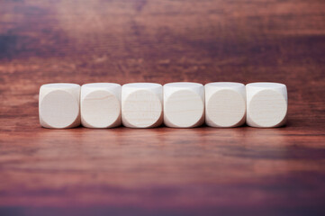 six wooden cubes in a row, free space for letters, symbols or any text