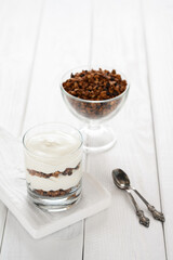 Greek yogurt with granola in glass jar. Parfait