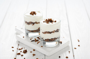 Greek yogurt with granola in glass jar. Parfait