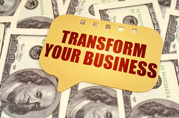 On the dollars is a sign with the inscription - Transform your business