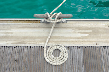 Mooring rope with a knotted end tied around a cleat