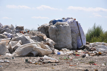 Plastic bottles in the bags with other trash at the city landfill