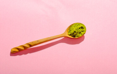 Matcha tea powder in wooden spoon