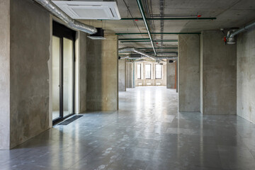 Company office with a gray walls in ndustrial style interior with big windows