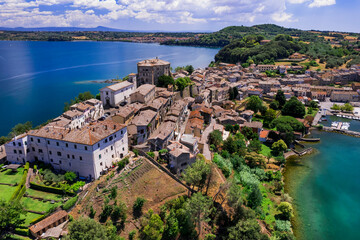 Fototapeta na wymiar Scenic lakes of Italy - beautiful Bolsena. aerial view of Capodimonte medieval village. Viterbo province, Lazio region