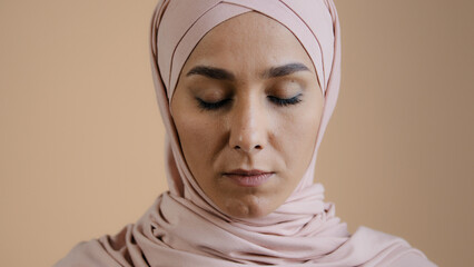 Portrait of pretty upset muslim girl woman in hijab headscarf islamic young anxious lonely lady in...