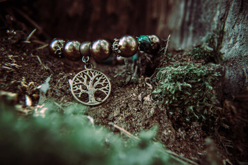 amulet lying on a moss on a dark natural background. pagan wiccan, slavic traditions. Witchcraft,...