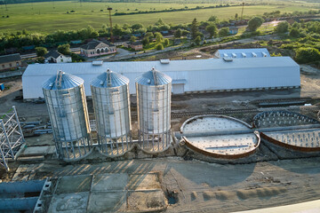 Aerial view of industrial ventilated silos for long term storage of grain and oilseed. Metal...