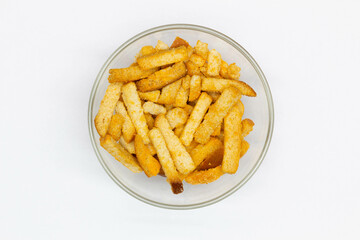 Bread rusks in a transparent glass bowl on a white background. Isolated. Dessert and snack. Wheat rye crackers. Fried croutons to beer. Sliced toast. Flour product. Close-up. Top view