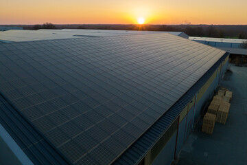 Blue photovoltaic solar panels mounted on building roof for producing clean ecological electricity...