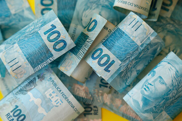 money from brazil - detail in scattered hundred reais bills