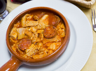 Dish of Spanish cuisine. Stewed tripe (Callos) in salsa with garbanzos and chorizo sausage served in clayware..