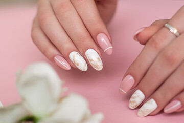 
Beautiful female hands with luxury manicure nails, pink and white gel polish