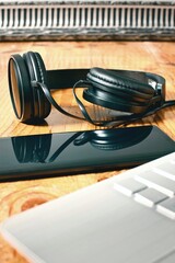 Fototapeta na wymiar Closeup shot of black headphones reflected in smartphone screen 