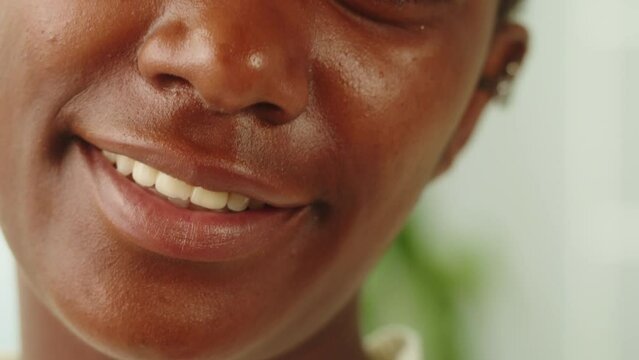 Native African American woman portrait. Female person smiling. Close-up of toothy smile, mouth, happy face. Pretty latin model. 