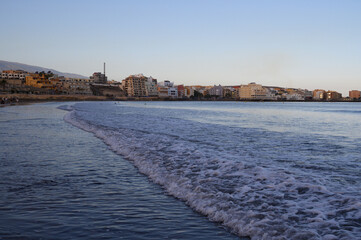 Fototapeta na wymiar Evening on sandy beach in El Medano, south of Tenerife island, Canary, Spain