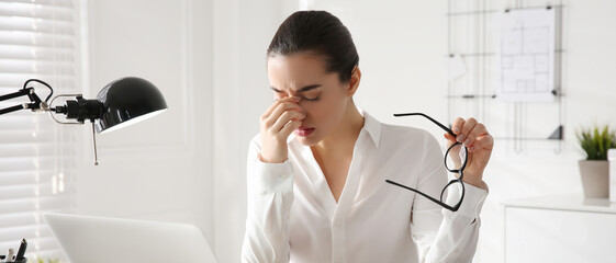 Stressed and tired young woman with headache at workplace. Banner design