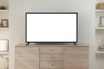 Modern TV set on wooden cabinet in room