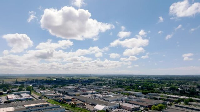 Panoramic View Of Industrial Buildings And Landscape Near YVR Airport In Richmond, British Columbia, Canada. aerial, pan right