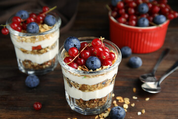 Delicious yogurt parfait with fresh berries on wooden table, closeup