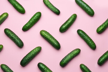 Flat lay composition with fresh ripe cucumbers on pink background