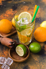 healthy lemonade, citrus water or mojito cocktails, with lime, lemon, orange, ice and mint,