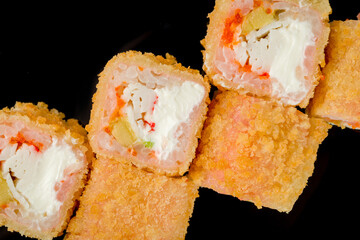 Hot kaisen roll with crab and spicy sause. chinese cuisine on black with reflection