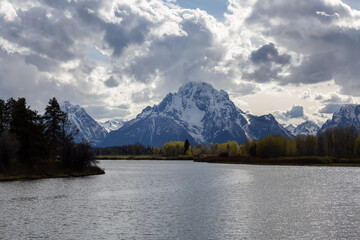 River surrounded by Trees and Mountains in American Landscape. Snake River, Oxbow Bend. Spring Season. Grand Teton National Park. Wyoming, United States. Nature Background.